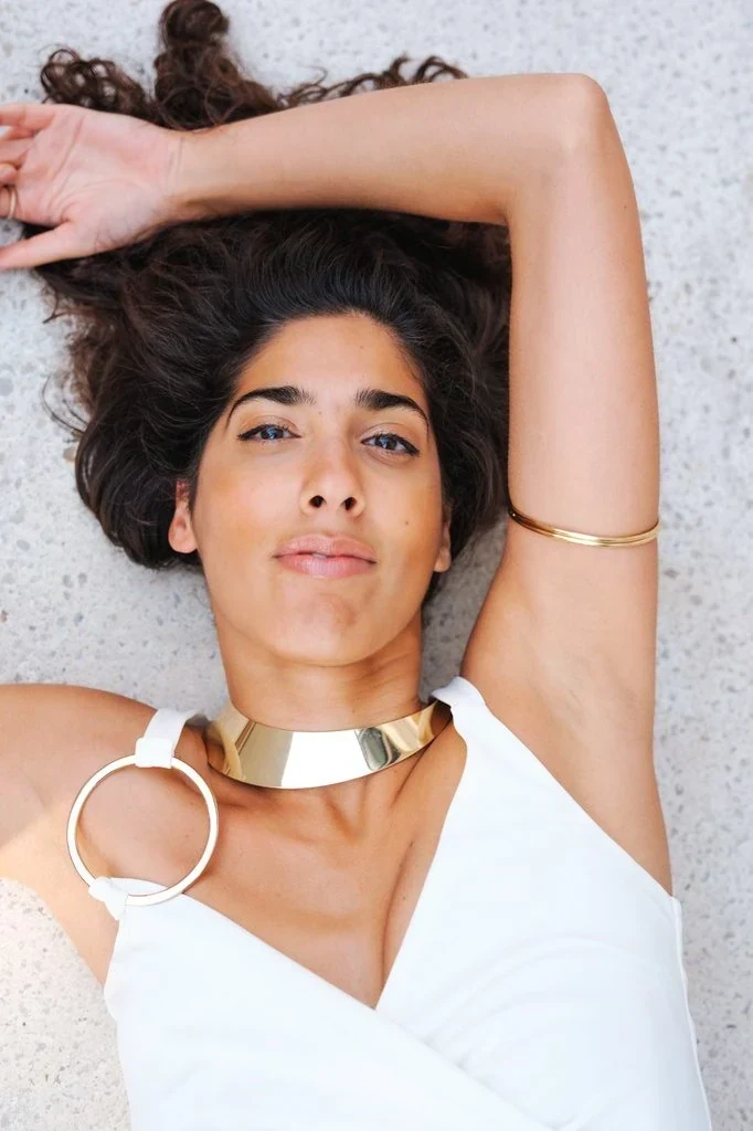 Arms raised, lying down pose: Raising both arms above your head while lying down opens up the neck and collarbone and turns a simple reclined shot into a strong, symmetrical shape.