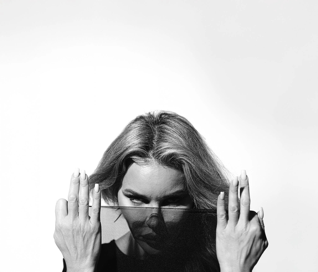 Hands covering the face, fingers spread